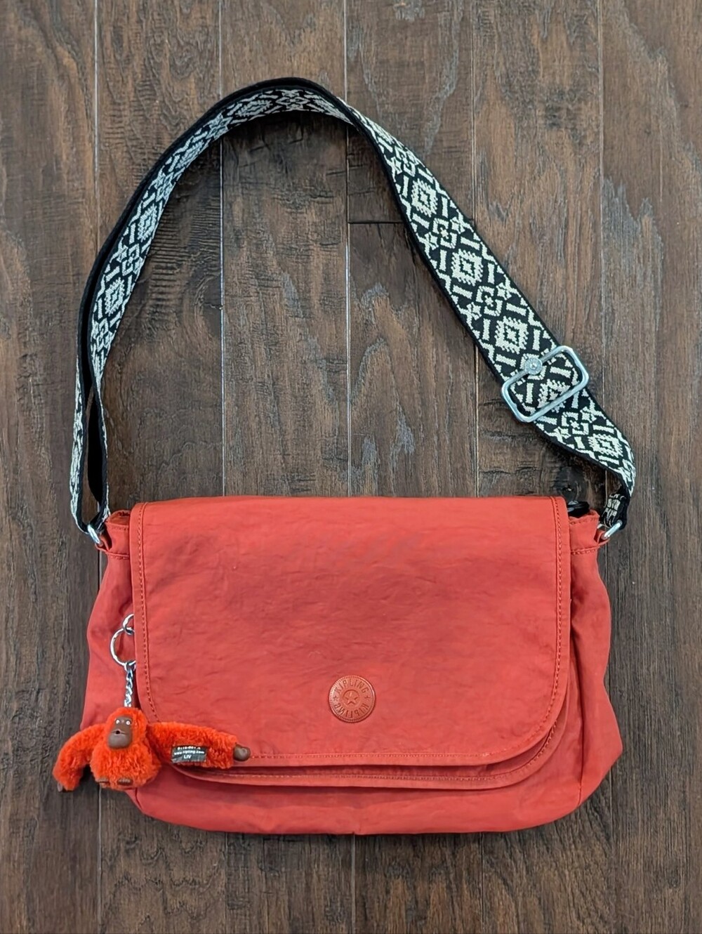 Kipling Crossbody Bag in Brick Red with Patterned Strap & Signature Gorilla Toy